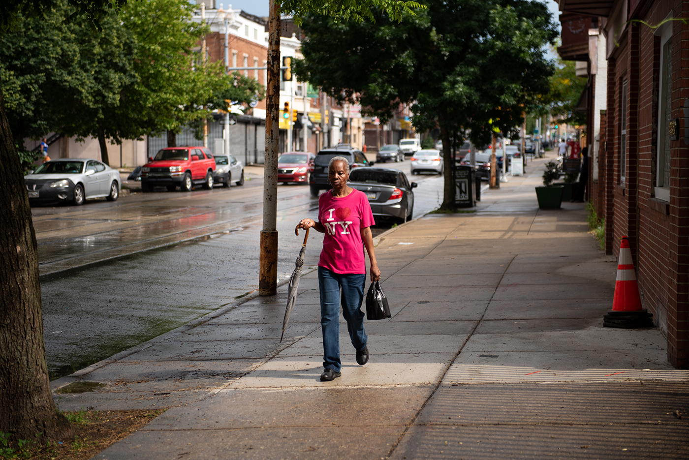 A neighborhood woman, Theresa Gollins, walking along Germantown Avenue in Nicetown. [Kriston Jae Bethel for Places Journal]