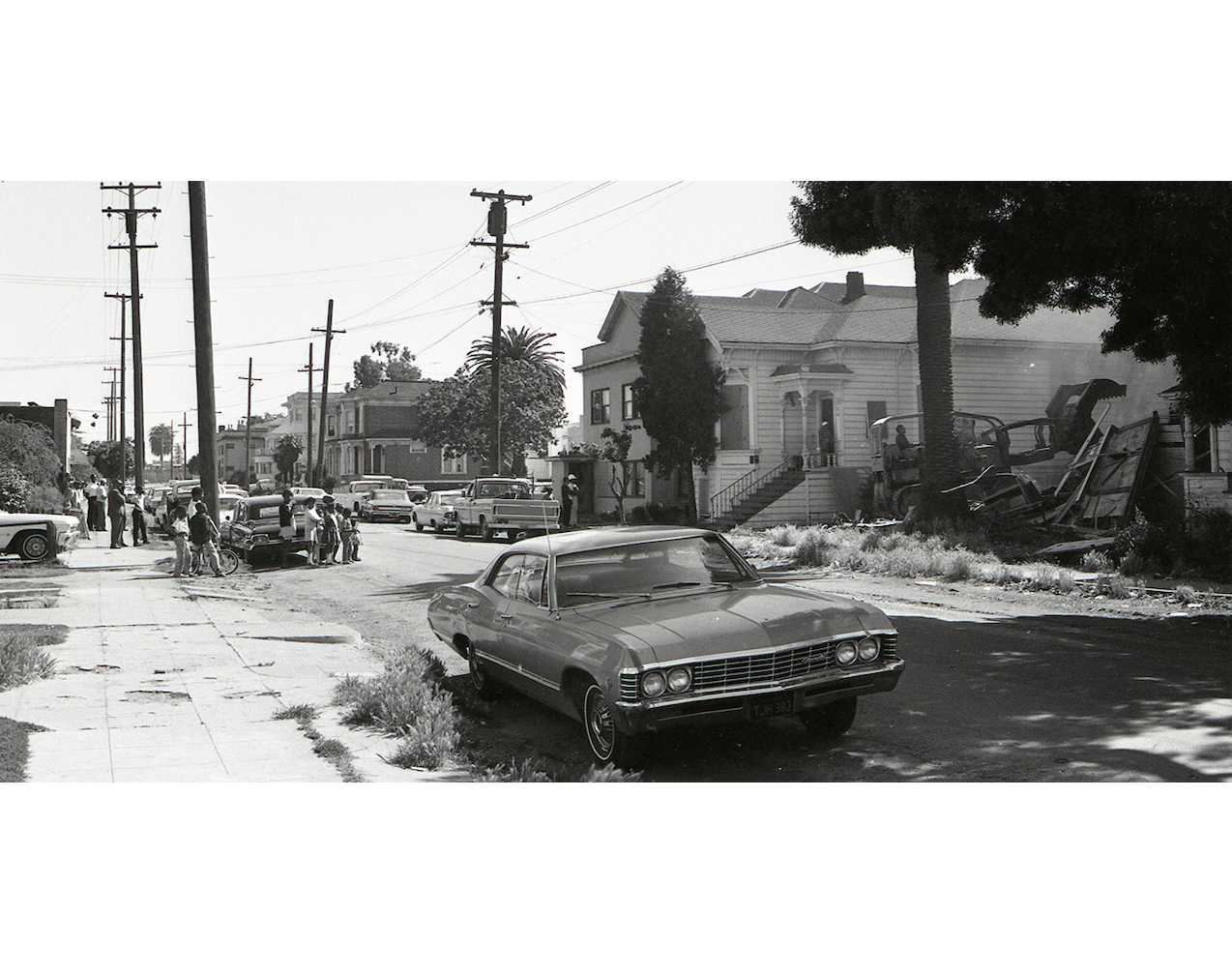 Children watch as a house is bulldozed in West Oakland, June 12, 1968.