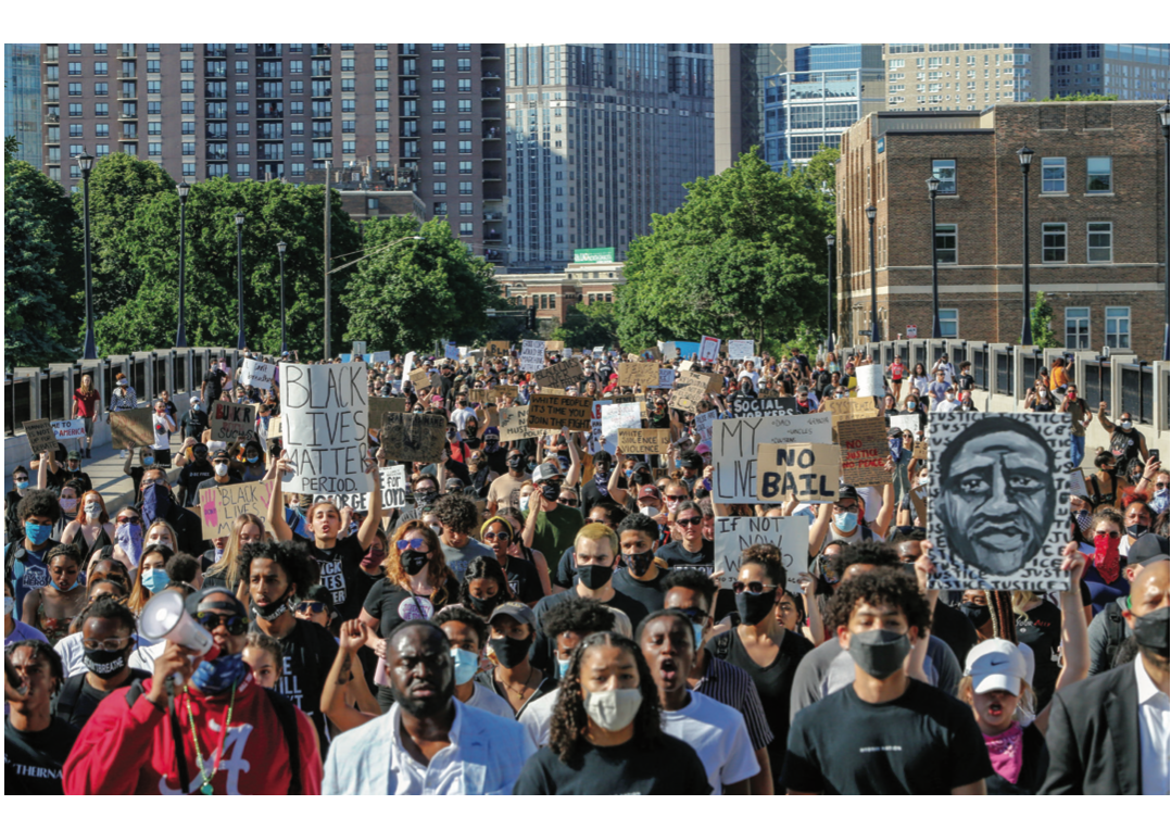 On June 5, thousands of protesters marched from downtown Minneapolis (above) to the site of George Floyd’s arrest. A 1936 photograph shows the NAACP’s flag (bottom) flying over Fifth Ave.