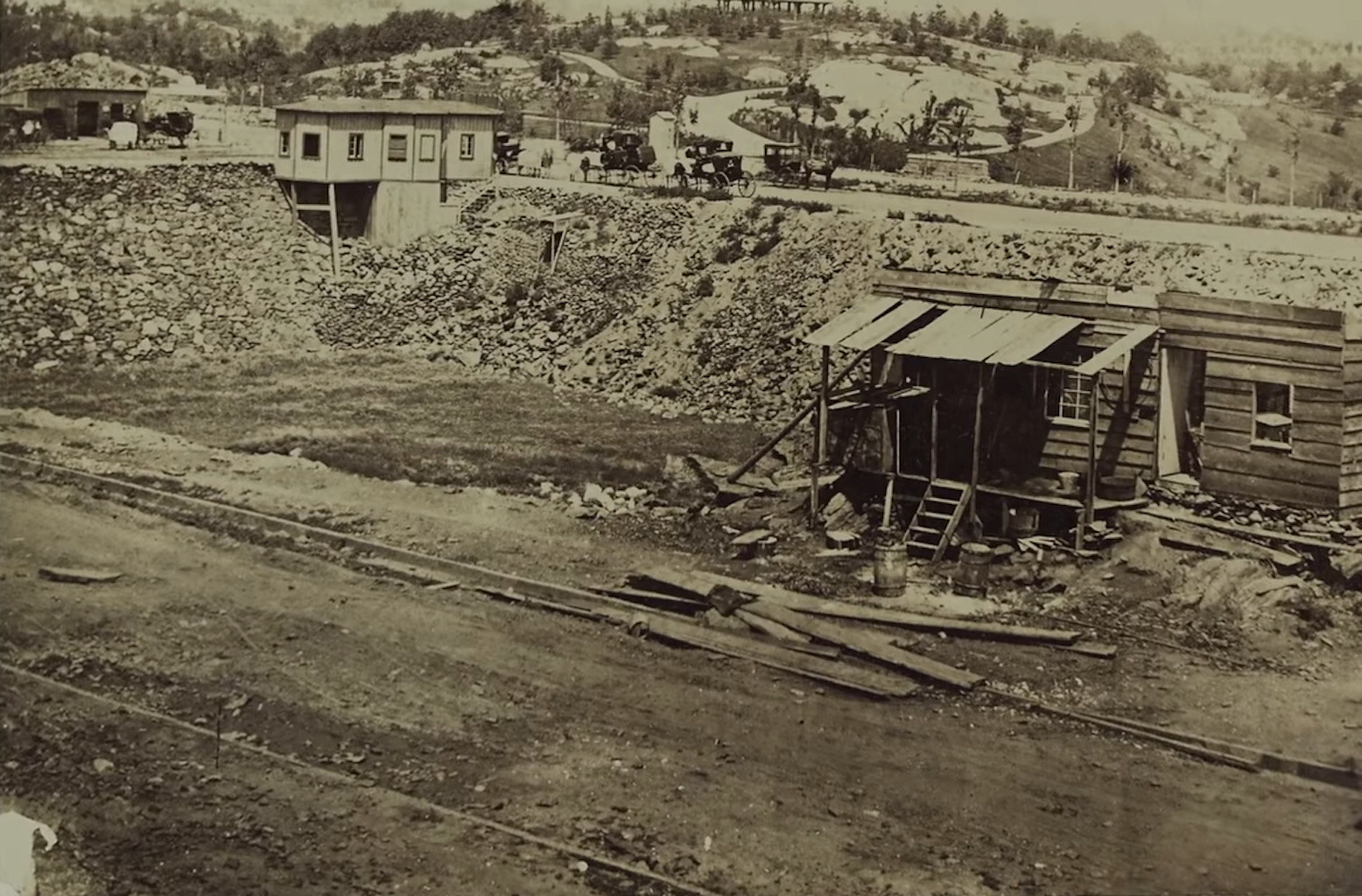 Eighteenth century photo of Seneca Village. Small structures and homes stand in an open landscape.