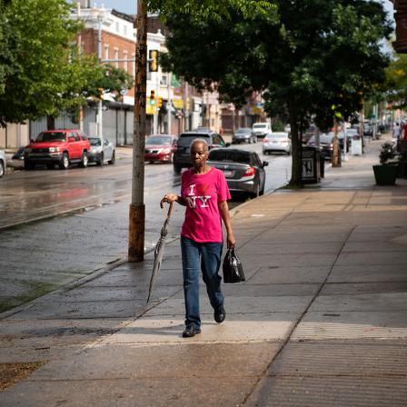 A neighborhood woman, Theresa Gollins, walking along Germantown Avenue in Nicetown. [Kriston Jae Bethel for Places Journal]