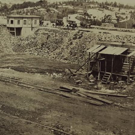 Eighteenth century photo of Seneca Village. Small structures and homes stand in an open landscape.